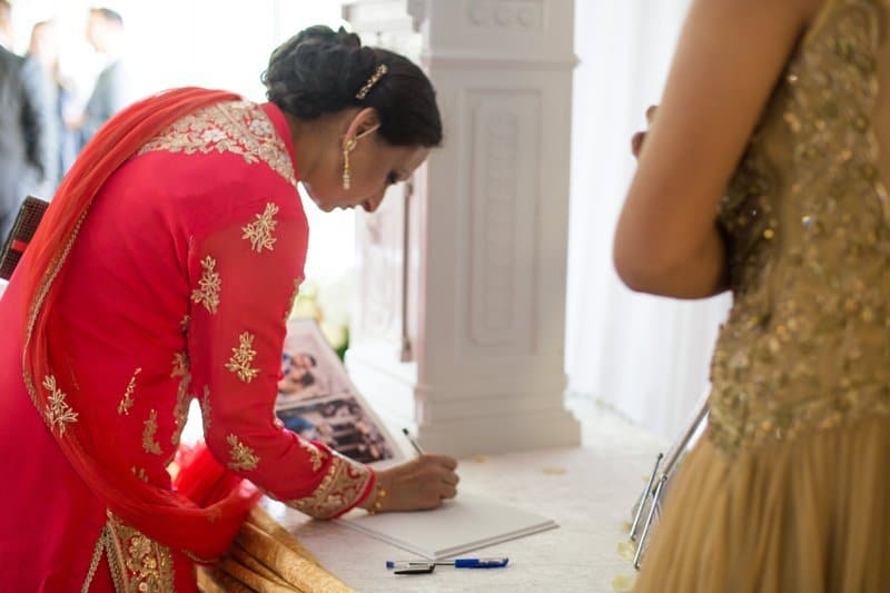 lady signing a guest book