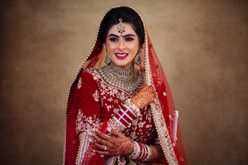 bride pose in front of poratbale backdrop 1