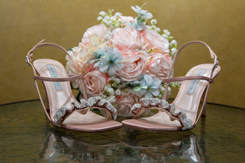 brides shoes in front of flowers 1